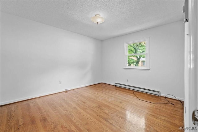 3304 N Marion Ave, Hopewell, VA 23860 - spare room featuring a baseboard radiator, wood finished floors, a textured ceiling, and baseboards