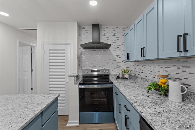 1505 Enon Church Rd, Chester, VA 23836 - kitchen featuring wall chimney exhaust hood, stainless steel range with electric cooktop, wood finished floors, blue cabinets, and decorative backsplash