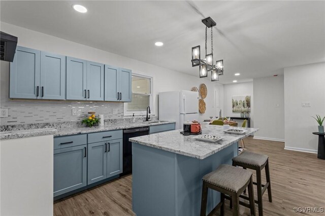 1505 Enon Church Rd, Chester, VA 23836 - kitchen featuring freestanding refrigerator, dishwasher, a kitchen breakfast bar, backsplash, and wood finished floors