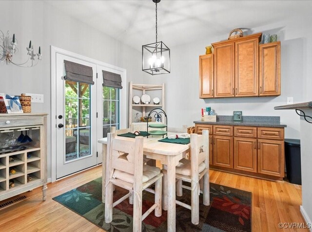 2013 Rose Family Dr, Midlothian, VA 23112 - dining area with light wood-style flooring and a chandelier