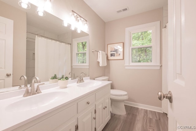 8282 Briarthorn Ct, Mechanicsville, VA 23116 - full bath featuring plenty of natural light, wood finished floors, toilet, and baseboards