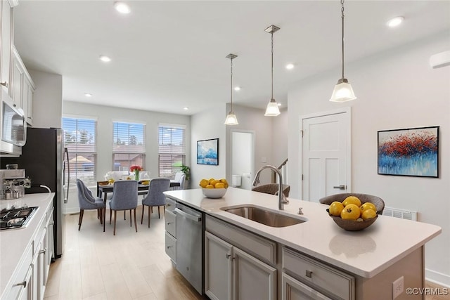 1906 Chartermark Dr, Midlothian, VA 23114 - kitchen with a sink, appliances with stainless steel finishes, light countertops, an island with sink, and pendant lighting