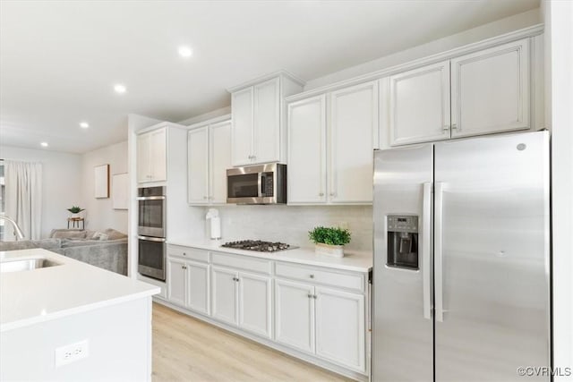1906 Chartermark Dr, Midlothian, VA 23114 - kitchen with stainless steel appliances, a sink, decorative backsplash, light countertops, and recessed lighting