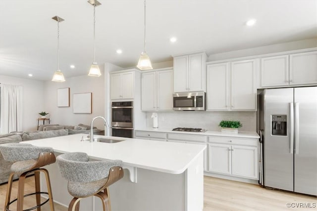 1906 Chartermark Dr, Midlothian, VA 23114 - kitchen with appliances with stainless steel finishes, a sink, open floor plan, light countertops, and an island with sink