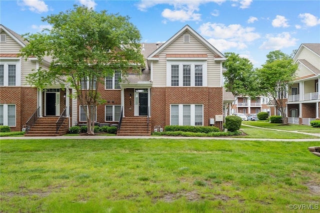 view of front of property featuring brick siding and a front lawn
