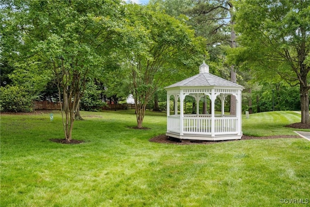 view of green lawn featuring a gazebo and view of scattered trees