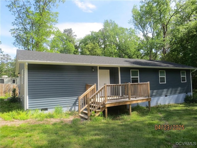 rear view of property with crawl space, a lawn, and a wooden deck