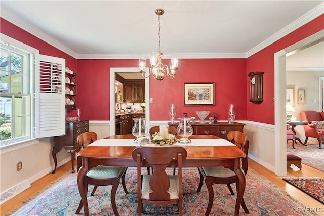 7290 Hill View Dr, Mechanicsville, VA 23111 - dining area featuring a chandelier, light wood-style flooring, and ornamental molding