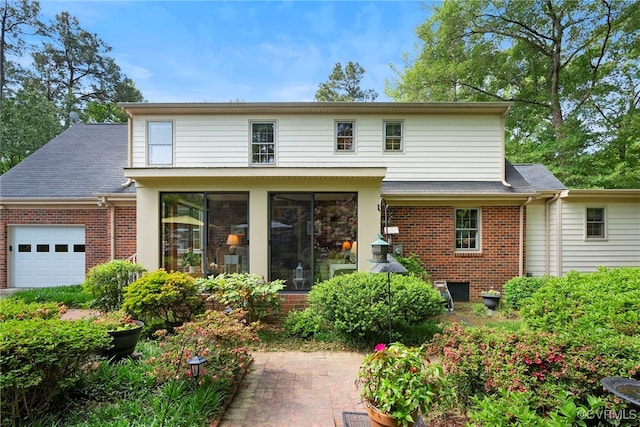 7290 Hill View Dr, Mechanicsville, VA 23111 - rear view of house with an attached garage, brick siding, a sunroom, and roof with shingles