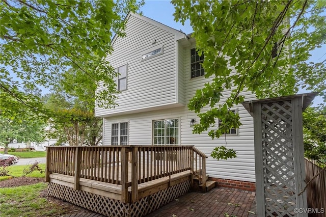 rear view of house featuring a wooden deck