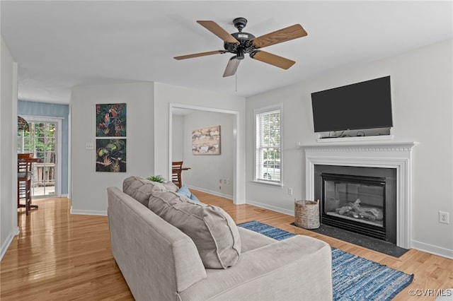 11441 Alder Glen Way, Glen Allen, VA 23059 - living room featuring light wood-type flooring, a fireplace with flush hearth, baseboards, and a ceiling fan