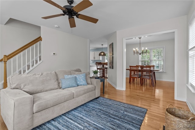 11441 Alder Glen Way, Glen Allen, VA 23059 - living area featuring light wood-style flooring, a chandelier, ceiling fan, stairway, and baseboards