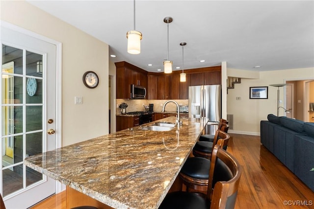 11602 Hardwood Dr, Midlothian, VA 23114 - kitchen with stainless steel appliances, a sink, a breakfast bar area, wood finished floors, and open floor plan