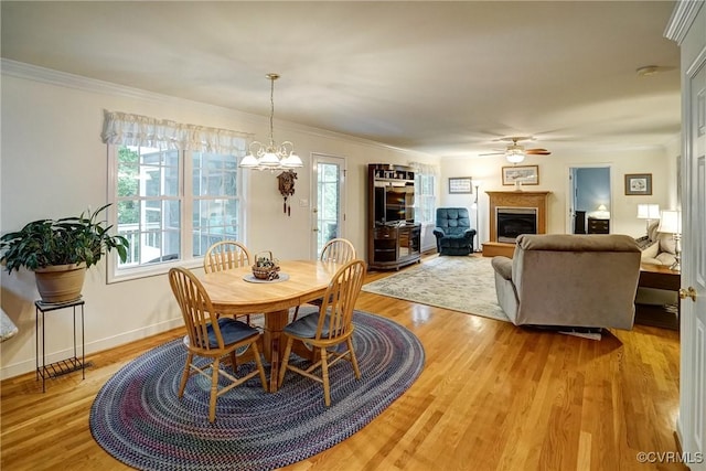 4329 Stebbins St, Chester, VA 23831 - dining area with a glass covered fireplace, a ceiling fan, light wood-style flooring, crown molding, and a chandelier