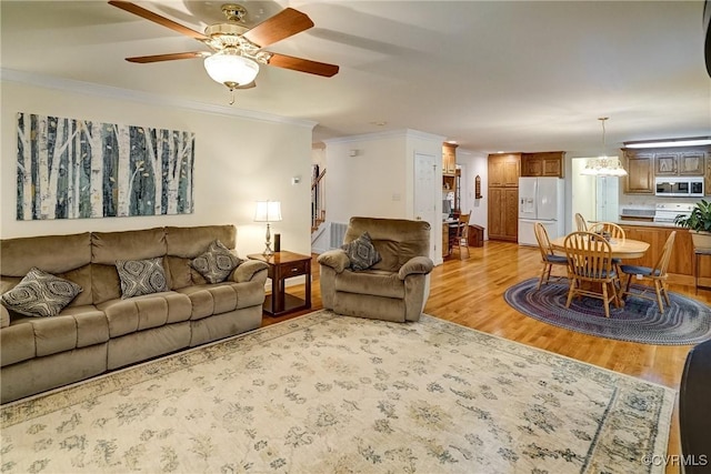 4329 Stebbins St, Chester, VA 23831 - living room featuring light wood-style floors, a ceiling fan, ornamental molding, and baseboards