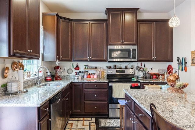 8421 Eden St, Henrico, VA 23228 - kitchen with appliances with stainless steel finishes, a sink, light stone countertops, dark brown cabinets, and pendant lighting