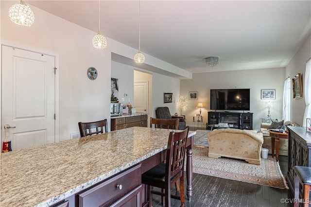 8421 Eden St, Henrico, VA 23228 - kitchen with dark wood-style floors, a kitchen breakfast bar, decorative light fixtures, and light stone counters