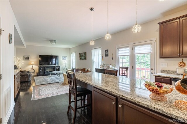 8421 Eden St, Henrico, VA 23228 - kitchen with dark wood finished floors, a kitchen breakfast bar, light stone countertops, and open floor plan