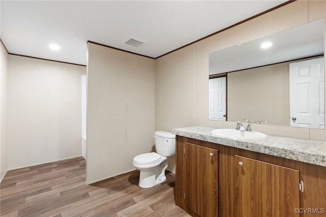 15011 Elm Cottage Rd, Amelia Courthouse, VA 23002 - bathroom with wood finished floors, toilet, vanity, crown molding, and recessed lighting