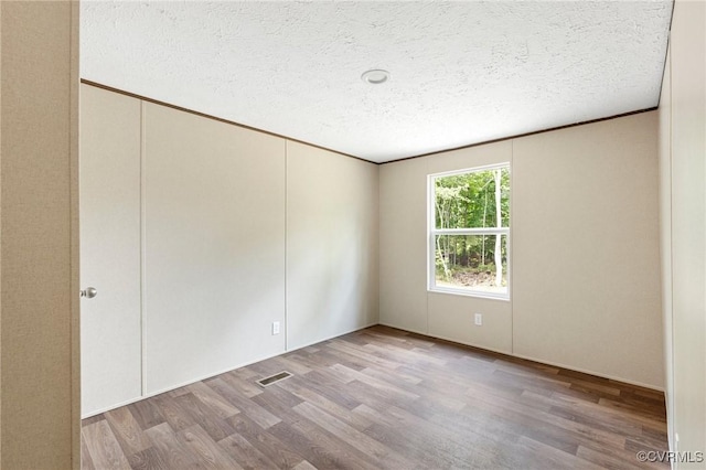 15011 Elm Cottage Rd, Amelia Courthouse, VA 23002 - empty room with wood finished floors and a textured ceiling