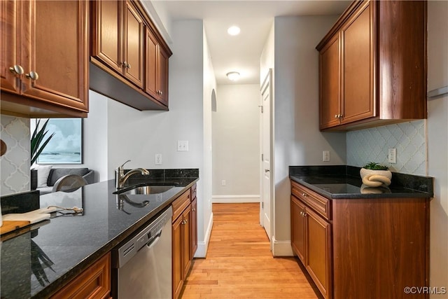 601 Roseneath Rd Unit U11, Richmond, VA 23221 - kitchen featuring stainless steel dishwasher, a sink, light wood-type flooring, tasteful backsplash, and dark stone countertops