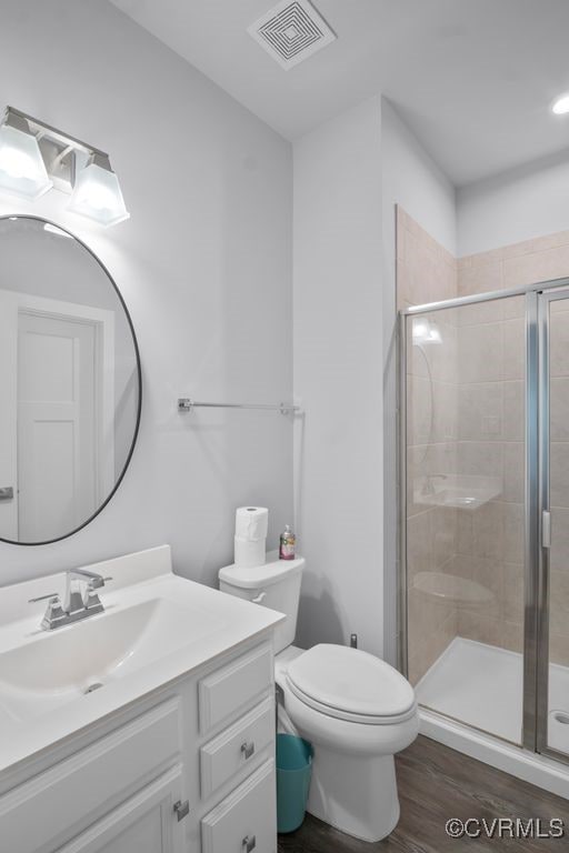 8136 Fedora Dr, Chesterfield, VA 23838 - bathroom with a stall shower, vanity, toilet, and wood finished floors