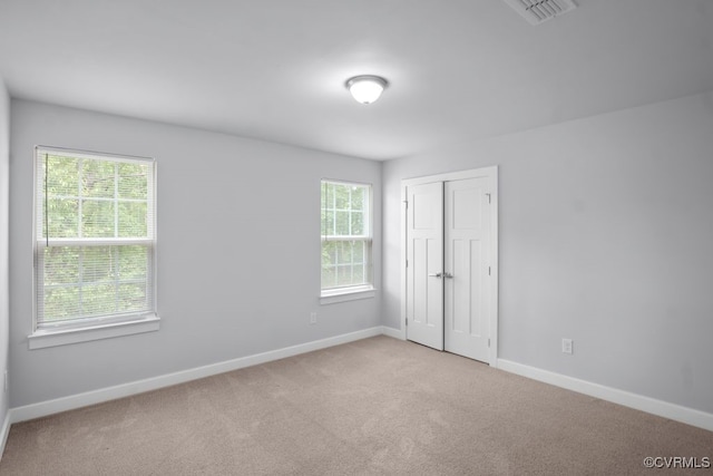 8136 Fedora Dr, Chesterfield, VA 23838 - unfurnished bedroom with multiple windows, carpet, baseboards, and a closet
