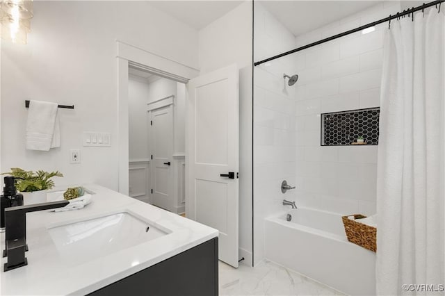 bathroom with marble look tile flooring, shower / tub combo, and double vanity