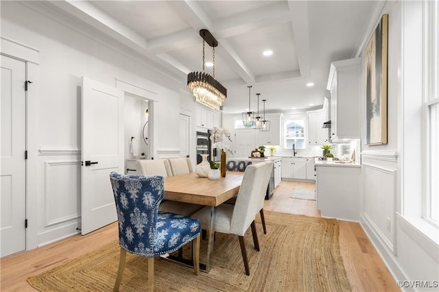 dining room featuring light wood-style floors, beamed ceiling, coffered ceiling, recessed lighting, and a chandelier