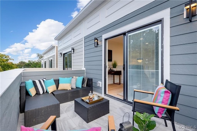view of patio with an outdoor living space and a balcony