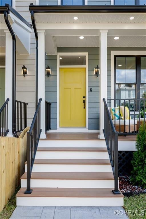 view of exterior entry featuring covered porch