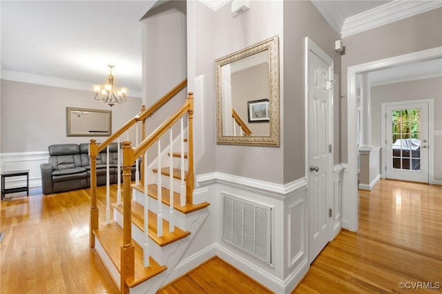 8413 Chandon Ct, Chesterfield, VA 23838 - staircase with wood finished floors, a chandelier, ornamental molding, and a wainscoted wall