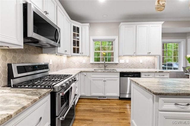8413 Chandon Ct, Chesterfield, VA 23838 - kitchen featuring stainless steel appliances, white cabinetry, healthy amount of natural light, and crown molding