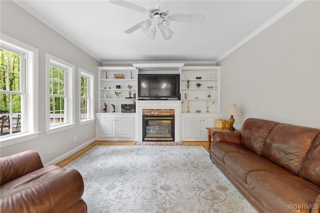 8413 Chandon Ct, Chesterfield, VA 23838 - living area with a brick fireplace, crown molding, light wood-style flooring, ceiling fan, and baseboards