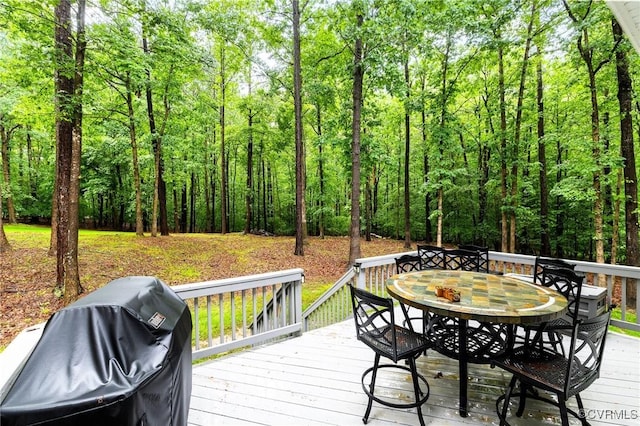8413 Chandon Ct, Chesterfield, VA 23838 - wooden deck with outdoor dining space, a grill, and a view of trees