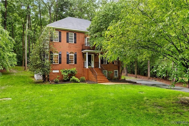 8413 Chandon Ct, Chesterfield, VA 23838 - colonial-style house featuring a balcony, a front yard, and brick siding