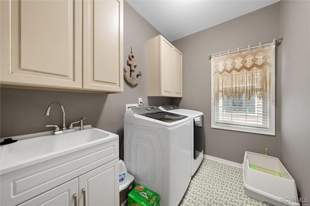 laundry room with separate washer and dryer, cabinet space, and baseboards