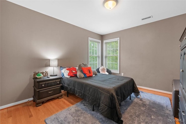 bedroom featuring light wood-style flooring and baseboards