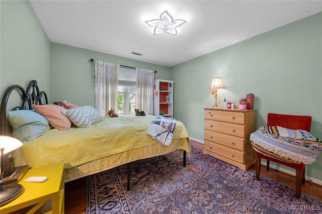 bedroom featuring wood finished floors and baseboards