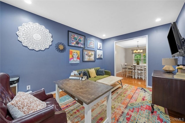 living area featuring a chandelier, wood finished floors, recessed lighting, and baseboards