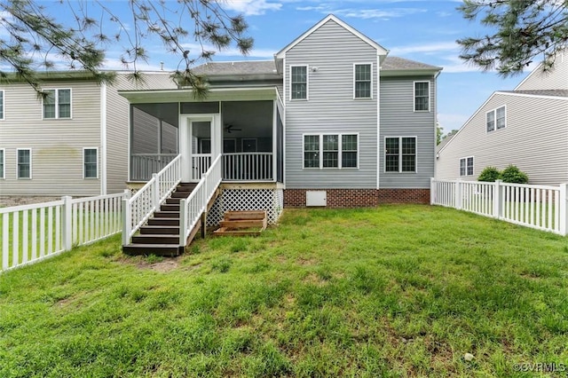 rear view of house featuring a sunroom, a ceiling fan, and a shingled roof