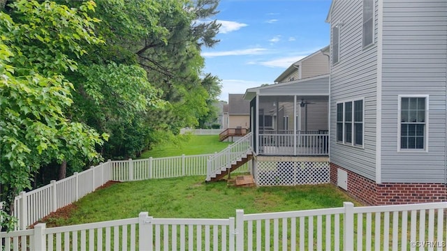 view of yard with a sunroom and stairs
