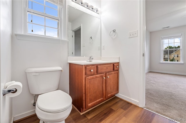 2909 Ginter St, Henrico, VA 23228 - half bathroom featuring toilet, vanity, wood finished floors, and baseboards