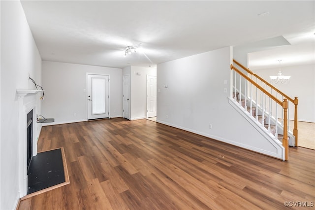 2909 Ginter St, Henrico, VA 23228 - unfurnished living room featuring stairway, wood finished floors, a chandelier, and baseboards