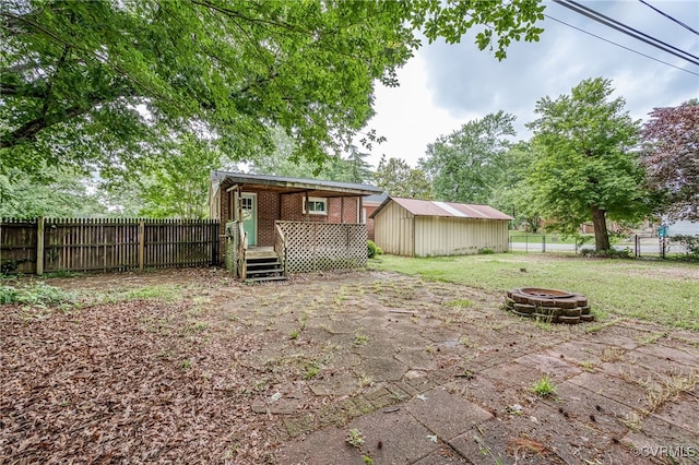 27 Medlock Rd, Sandston, VA 23150 - view of yard featuring an outdoor fire pit and an outdoor structure