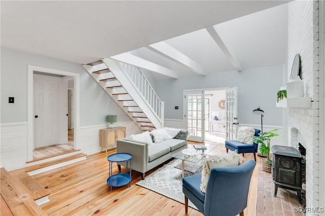 5905 Willow Creek Way, Richmond, VA 23225 - living room featuring stairway, beamed ceiling, a wainscoted wall, a wood stove, and french doors