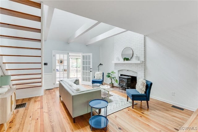 5905 Willow Creek Way, Richmond, VA 23225 - living area with french doors, light wood-type flooring, a wood stove, baseboards, and stairs