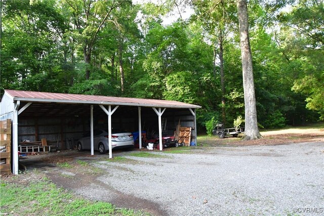 12387 Hanover Courthouse Rd, Hanover, VA 23069 - view of car parking with a carport, an outbuilding, and gravel driveway
