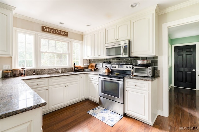 12387 Hanover Courthouse Rd, Hanover, VA 23069 - kitchen with appliances with stainless steel finishes, a sink, dark wood-style flooring, decorative backsplash, and ornamental molding