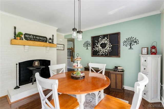 12387 Hanover Courthouse Rd, Hanover, VA 23069 - dining room with wood finished floors, crown molding, baseboards, and a brick fireplace